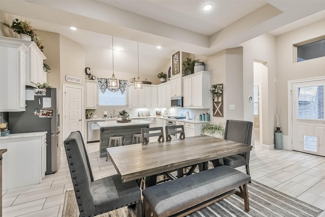 dining area featuring a high ceiling