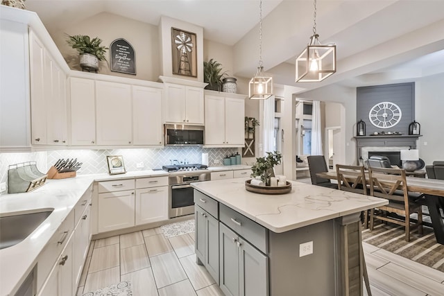 kitchen with white cabinetry, appliances with stainless steel finishes, and a kitchen island