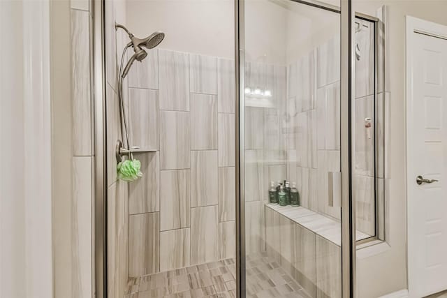 bathroom featuring a shower with shower door