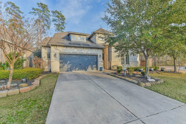 view of front of home featuring a garage and a front lawn