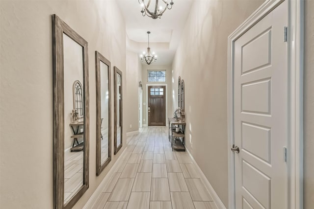 corridor with an inviting chandelier