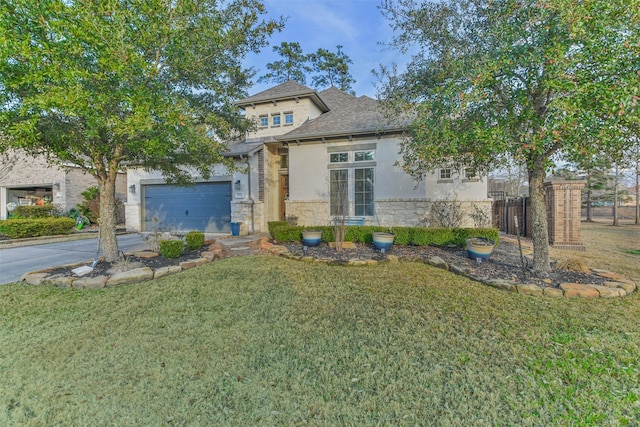 view of front facade with a garage and a front lawn