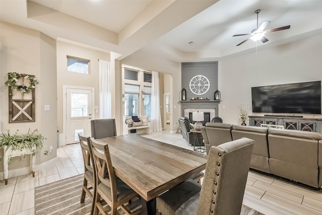 dining room with a raised ceiling and ceiling fan