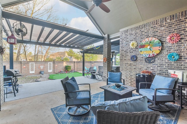 view of patio featuring area for grilling, a pergola, ceiling fan, and an outdoor fire pit