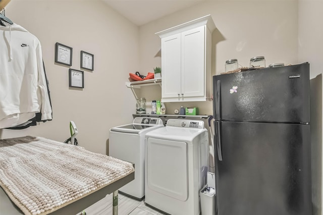 laundry room with cabinets and washer and dryer