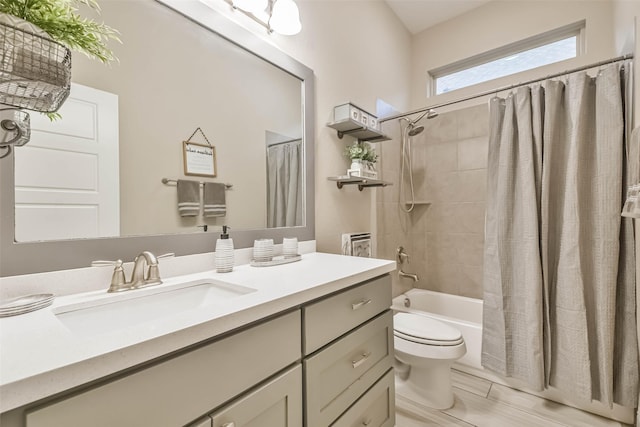 full bathroom with vanity, toilet, and shower / tub combo