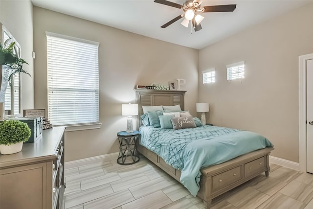 bedroom with ceiling fan and multiple windows