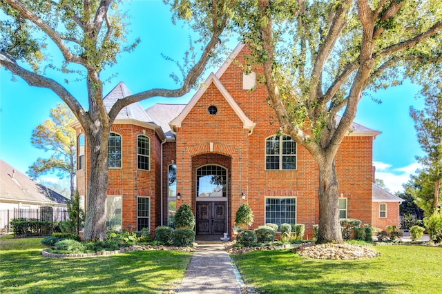 english style home with a front yard