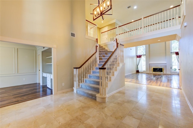 stairway with a chandelier and a high ceiling