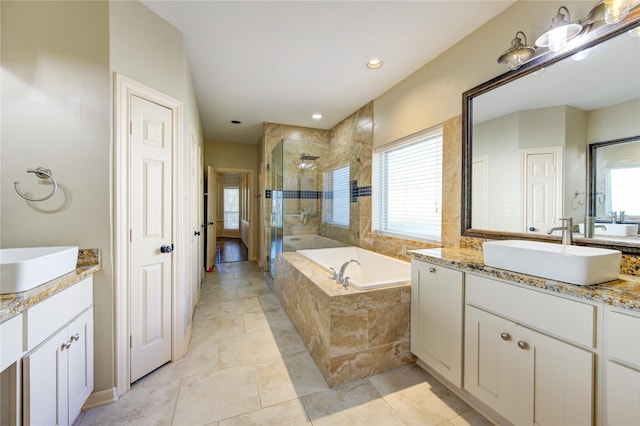 bathroom featuring vanity and separate shower and tub