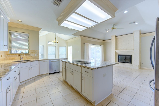 kitchen featuring vaulted ceiling, a kitchen island, decorative light fixtures, sink, and ornamental molding