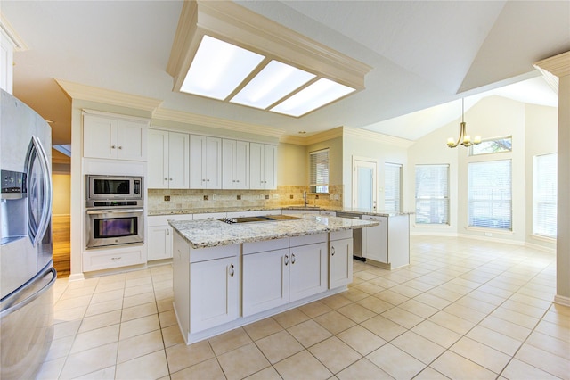 kitchen featuring light tile patterned flooring, white cabinetry, decorative light fixtures, a center island, and appliances with stainless steel finishes