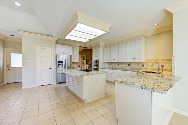 kitchen with sink, light tile patterned flooring, a center island, and appliances with stainless steel finishes