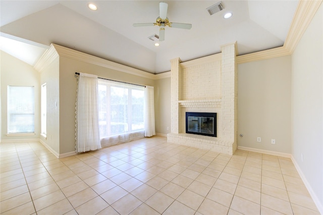 unfurnished living room with light tile patterned floors, vaulted ceiling, a fireplace, and a healthy amount of sunlight