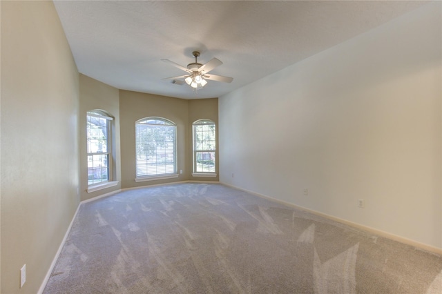 carpeted empty room with ceiling fan