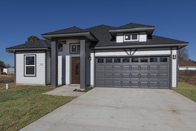 view of front of house featuring a garage and a front lawn