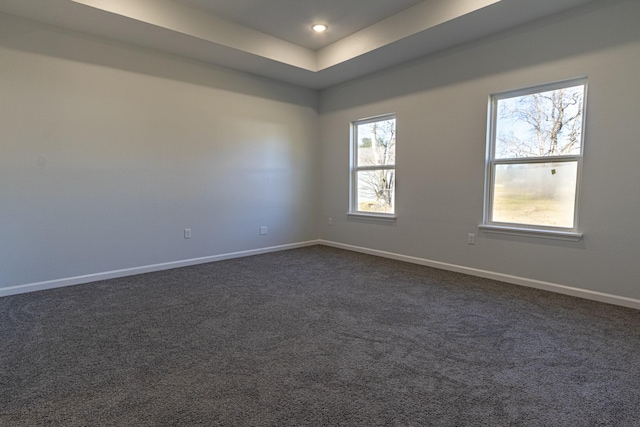 empty room featuring dark carpet