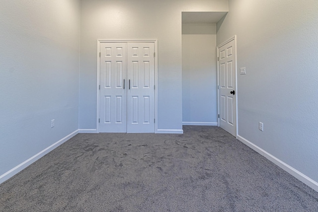 unfurnished bedroom featuring carpet floors and a closet