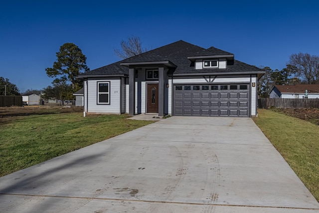 view of front facade featuring a garage and a front yard