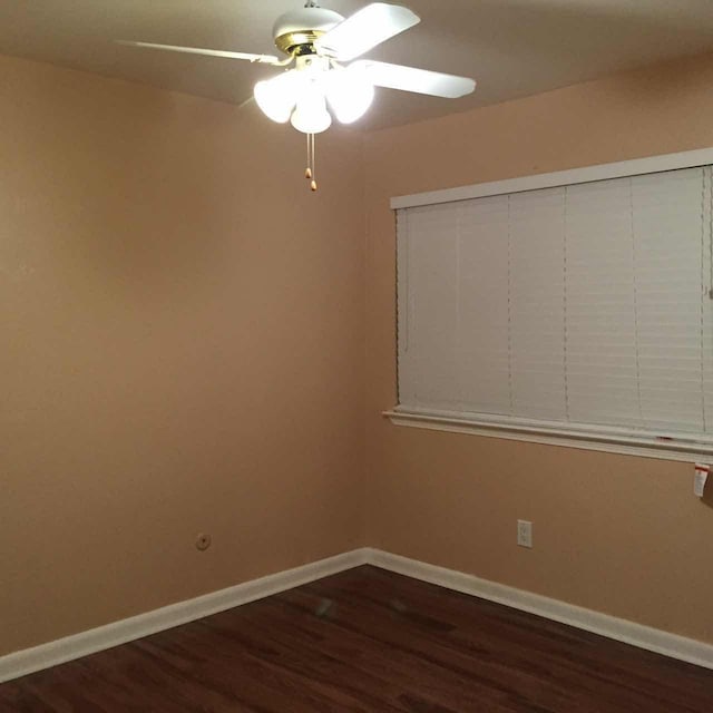 spare room with ceiling fan and dark hardwood / wood-style floors