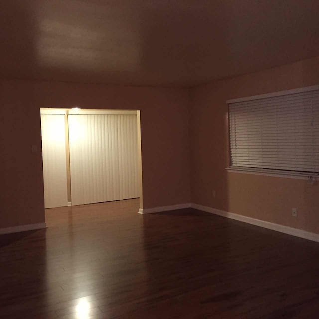 empty room featuring dark wood-type flooring