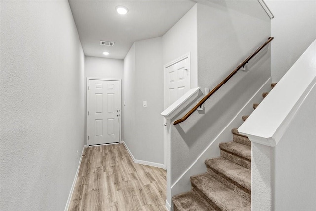 interior space with visible vents, baseboards, and wood finished floors