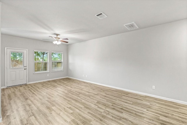 unfurnished room featuring visible vents, a ceiling fan, light wood-type flooring, and baseboards