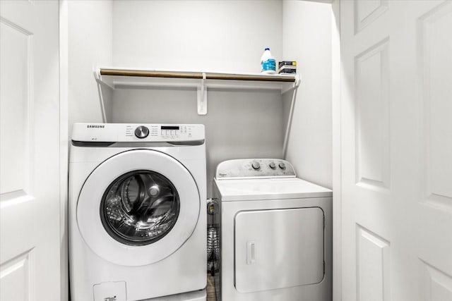 washroom featuring laundry area and washing machine and clothes dryer