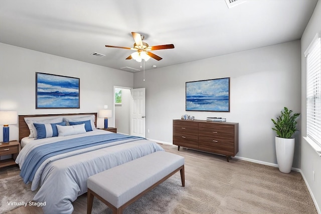 bedroom with visible vents, ceiling fan, light colored carpet, and baseboards