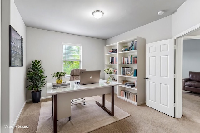 office area featuring light colored carpet and baseboards