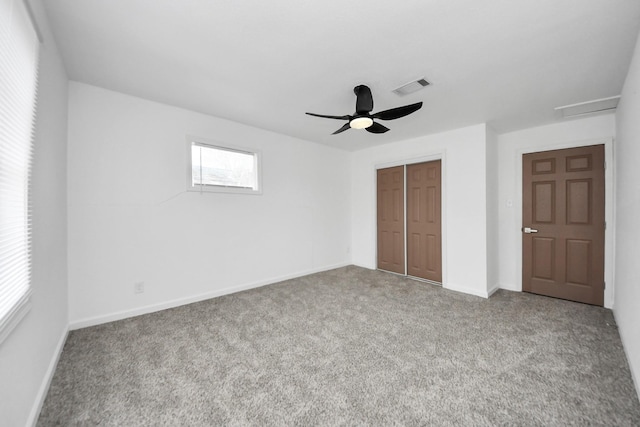 unfurnished bedroom with ceiling fan, a closet, and carpet