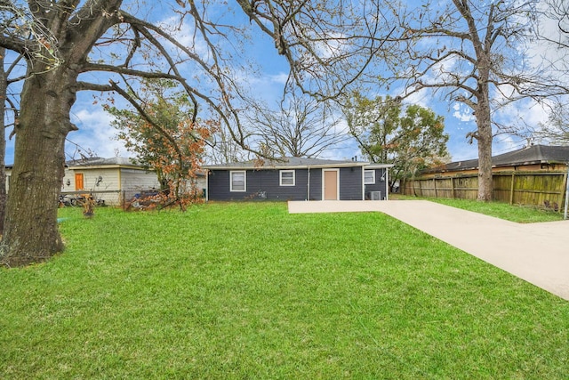 rear view of house featuring a yard