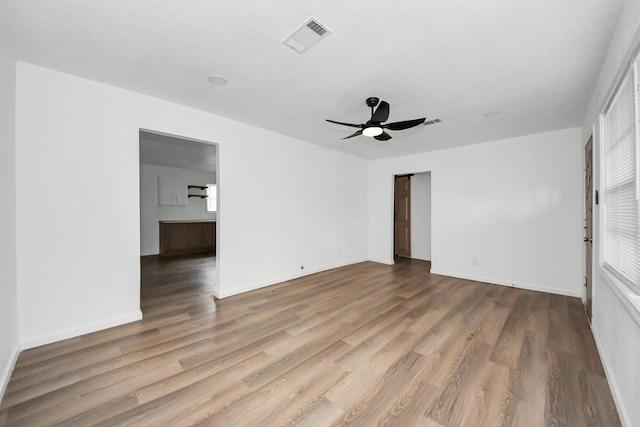 unfurnished room featuring hardwood / wood-style flooring and ceiling fan