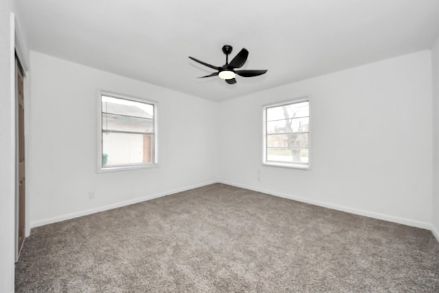 empty room with ceiling fan and light colored carpet