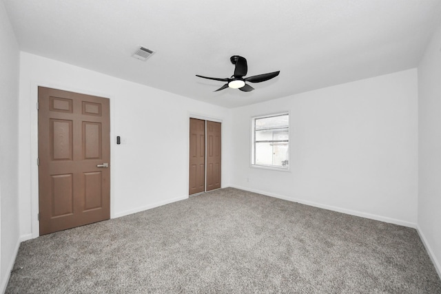 unfurnished bedroom with a closet, ceiling fan, and carpet flooring