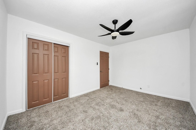 unfurnished bedroom with carpet, ceiling fan, and a closet