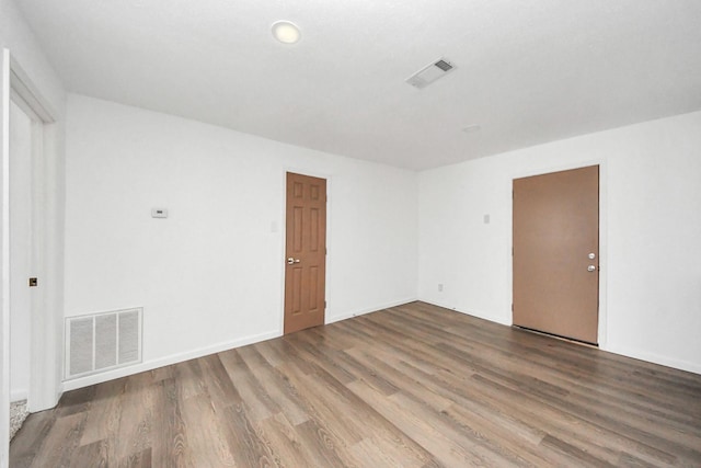 unfurnished room featuring wood-type flooring