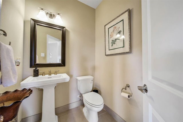 bathroom with sink, tile patterned floors, and toilet