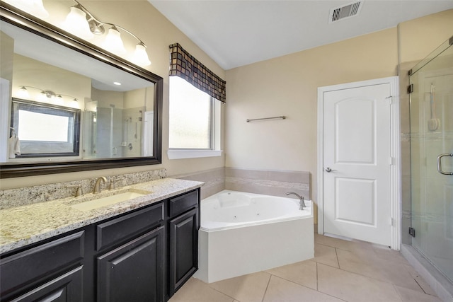 bathroom featuring tile patterned flooring, vanity, plenty of natural light, and separate shower and tub