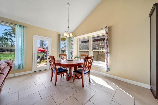 dining room featuring lofted ceiling, light tile patterned floors, and a chandelier