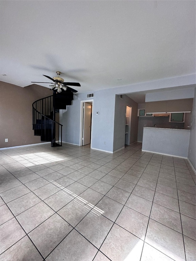 unfurnished living room with light tile patterned floors and ceiling fan