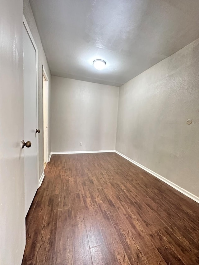 unfurnished room with dark hardwood / wood-style floors