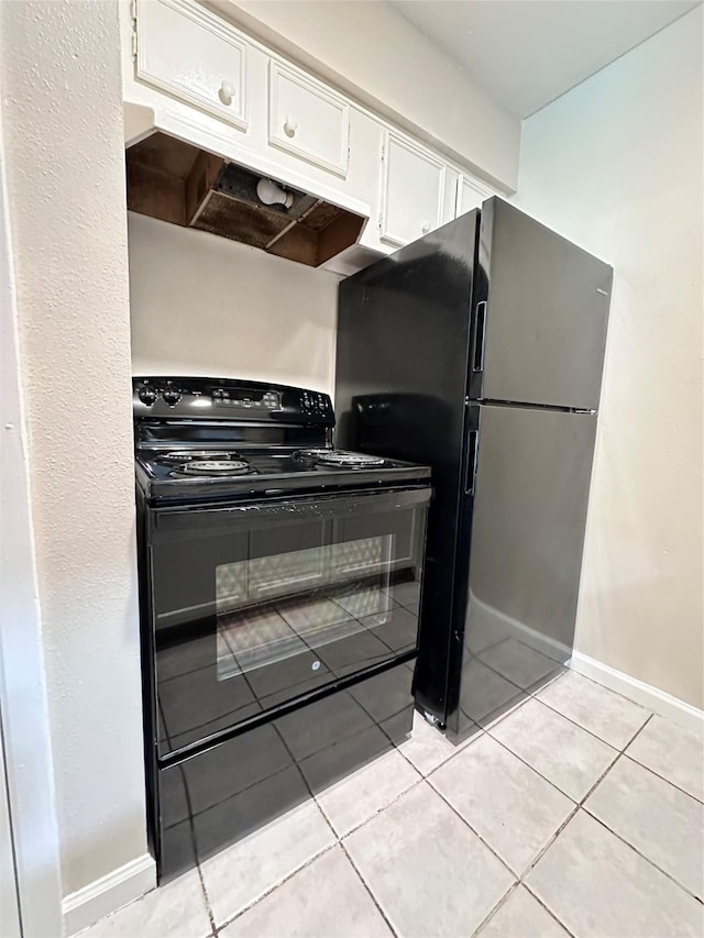 kitchen featuring light tile patterned floors, white cabinets, and black appliances