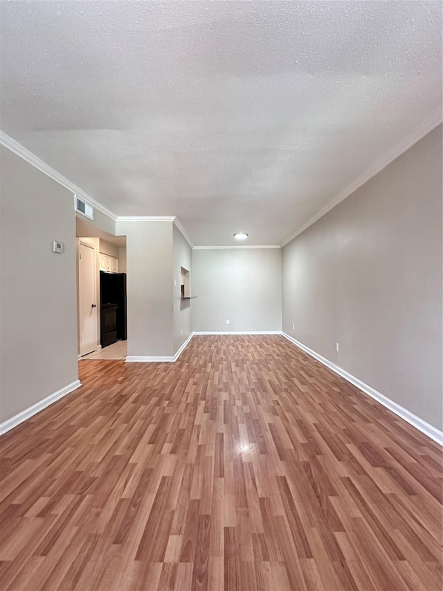 unfurnished living room with crown molding, a textured ceiling, and light hardwood / wood-style floors