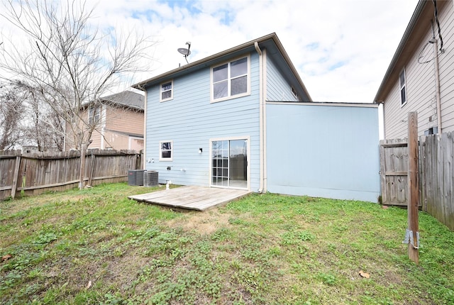 back of house featuring a wooden deck and a yard