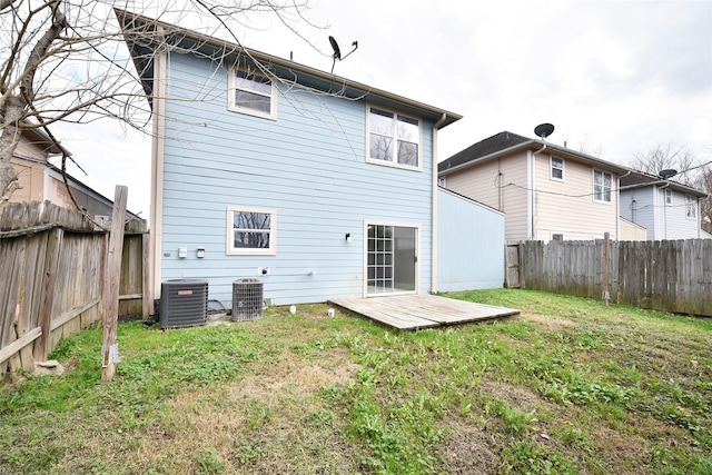 rear view of property featuring a wooden deck, a yard, and central AC unit