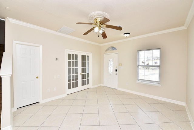 tiled entrance foyer featuring french doors, ceiling fan, and ornamental molding