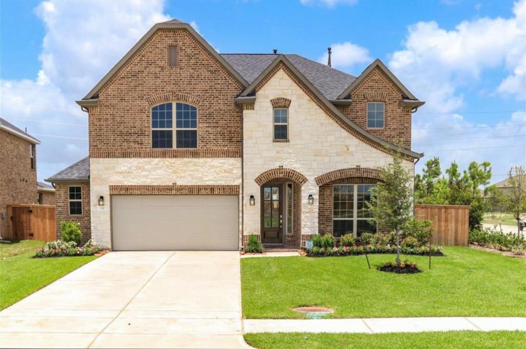 view of front of property featuring a garage and a front yard