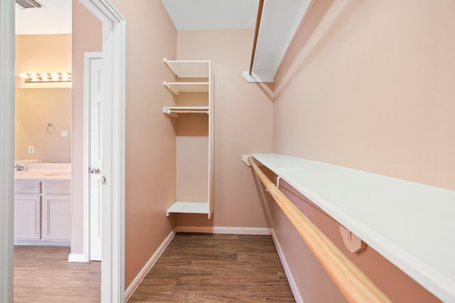 walk in closet featuring dark wood-type flooring