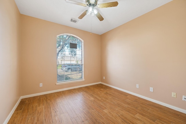 unfurnished room with ceiling fan and light wood-type flooring